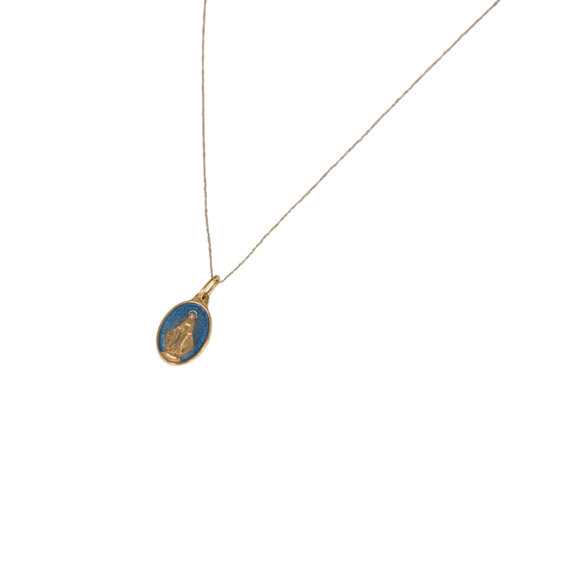Gold necklace with a blue pendant on a white background