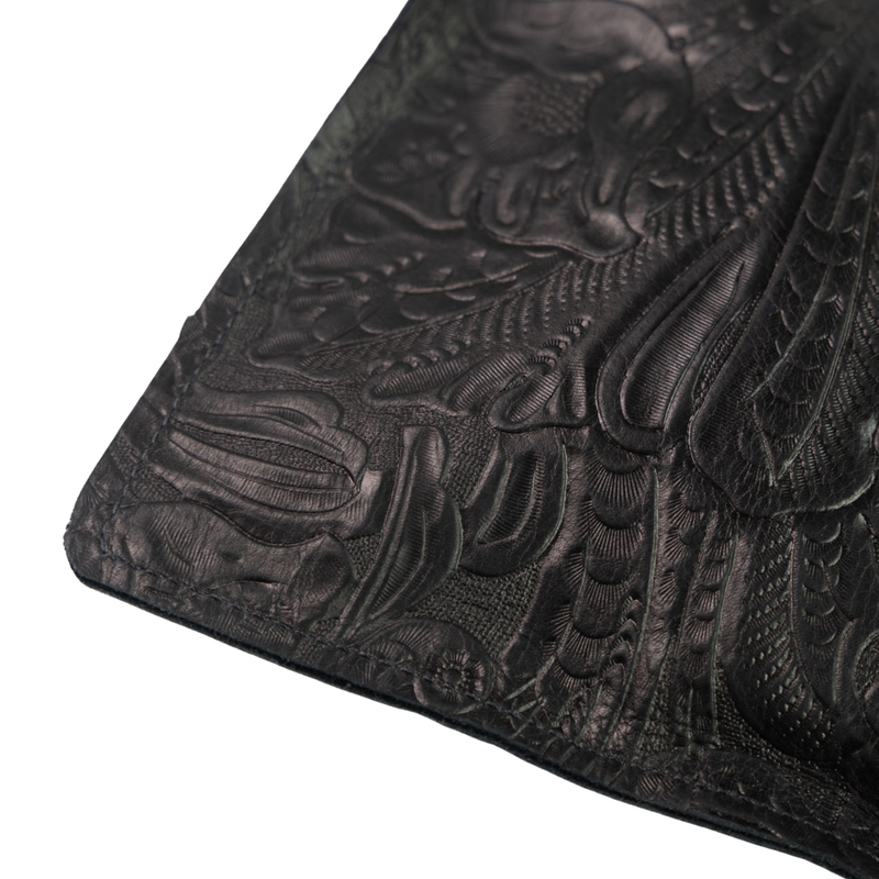 Good Tidings Styke Black leather wallet, One World Traveler Clutch, with intricate embossed design on a white background