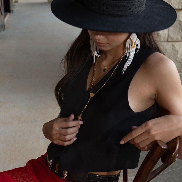 Gold Necklace with blue  medallion pendant on woman layered with Magical Rosary Necklace long